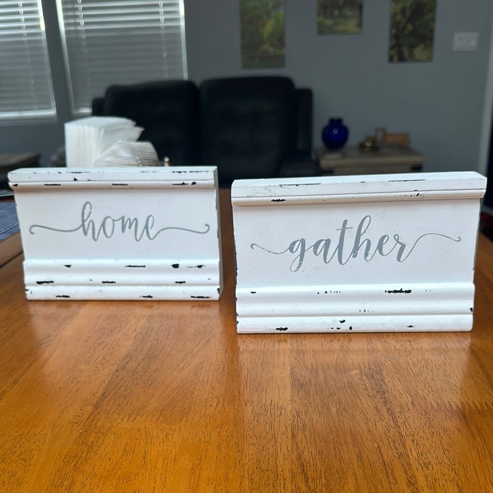 Quill to paper wood signs. “Gather” “Home”. White with gray writing.